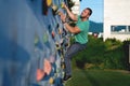 Young man climbing wall rock outdoors Royalty Free Stock Photo