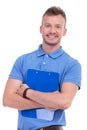 Young man with clipboard smiles at you Royalty Free Stock Photo