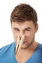 Young man with clothespin on his nose. Royalty Free Stock Photo