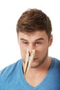 Young man with clothespin on his nose. Royalty Free Stock Photo