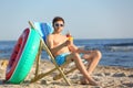Young man with cocktail in beach chair Royalty Free Stock Photo