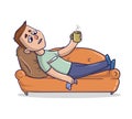 Young man with cold and running nose lies on a sandy-colored couch and takes medicine. Guy on a sofa feeling sick