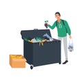 Young man collecting fruits and vegetables from waste container or trash bin. Male freegan searching for leftover food Royalty Free Stock Photo