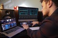 Young Man Composing Music on Laptop Computer in Bedroom Royalty Free Stock Photo