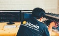 A young man configures hardware for bitcoin mining