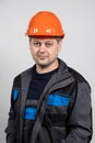 A young man construction worker in a safety helmet and work uniform on a white background Royalty Free Stock Photo