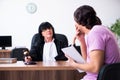 Young man consulting with judge on litigation issue Royalty Free Stock Photo