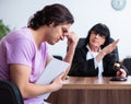 Young man consulting with judge on litigation issue Royalty Free Stock Photo