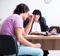 Young man consulting with judge on litigation issue Royalty Free Stock Photo