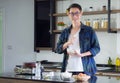 Young man cook wearing casual cloth in the kitchen. Young man worker uses whisk and bowl for making mixing ingredients in a bowl Royalty Free Stock Photo