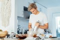 Young man cooking brownie cake on the light modern kitchen at home. Preparing steps for baking cake. Culinary hobby Royalty Free Stock Photo