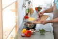 Young man cooking delicious vegetable soup in kitchen Royalty Free Stock Photo