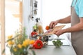 Young man cooking delicious vegetable soup in kitchen Royalty Free Stock Photo