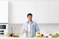 Young man cooking in modern kitchen, preparing breakfast Royalty Free Stock Photo