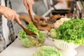 Young man cooking vegetable salad in kitchen Royalty Free Stock Photo