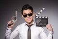 Young man in cool sunglasses holding gun isolated Royalty Free Stock Photo