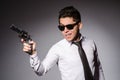 Young man in cool sunglasses holding gun isolated Royalty Free Stock Photo