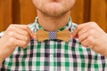 Young man correcting his bowtie Royalty Free Stock Photo