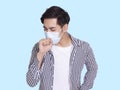 Young man coughs and wears a protective medical mask to prevent infection Royalty Free Stock Photo