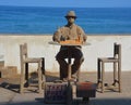 Young man cover of sand play chess game