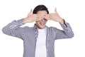 Young man covering eyes with hands and laughing.Isolated on white background