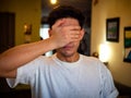 Young man covering eyes with his hand Royalty Free Stock Photo
