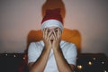 Young man covers his face with his hands out of fear. Gentleman sitting on couch and watching horror movie. Fear, feeling hopeless