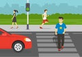 Young man crossing road on crosswalk with traffic lights. Look both ways before you cross the street.
