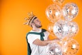 Young man with crown and air balloons Royalty Free Stock Photo