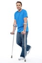 Young man with crutches trying to walk Royalty Free Stock Photo