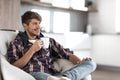 Young man with a Cup of coffee in the background in the kitchen