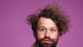 Young man with curly hair anf long beard and mustache