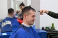 The young man cut his hair at the hairdresser. haircut at the hairdresser. Barbershop Royalty Free Stock Photo