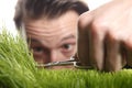 Young man cuts English lawn