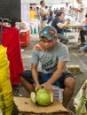 Young man cutting the coconut