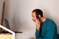 Young man cutting his own hair during coronavirus lock down at home