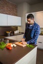 Young man cutting vegetables in the kitchen Royalty Free Stock Photo