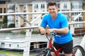 Young Man Cycling Next To River In Urban Setting Royalty Free Stock Photo