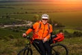 Young man cycling on a rural road through green meadow Royalty Free Stock Photo