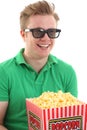 A young man with 3D glasses and a popcorn bucket