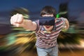 Young man is in 3D simulation of city. He is wearing virtual reality headset Royalty Free Stock Photo