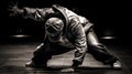 Young man dancing breakdance in the dark, studio shot.