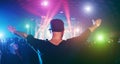 Young man dancing in night club festival event party with laser lights and dj playing in background - Happy people having fun Royalty Free Stock Photo