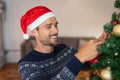 Young man decorating christmas tree Royalty Free Stock Photo