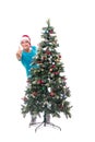 The young man decorating christmas tree isolated on white Royalty Free Stock Photo