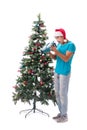The young man decorating christmas tree isolated on white Royalty Free Stock Photo