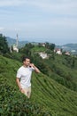 Young man degustating tea among tea bushes Royalty Free Stock Photo