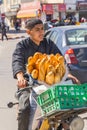 Young man delivering loaves of bread by scooter in the Houmt Souk