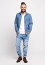 Young man in denim suit. Handsome man in denim jacket and jeans on a white background. Photo for advertising men`s jeans and