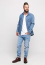 Young man in denim suit. Handsome man in denim jacket and jeans on a white background. Photo for advertising men`s jeans and